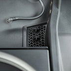 Black textured plastic door pocket storage compartment with a honeycomb mesh pattern.