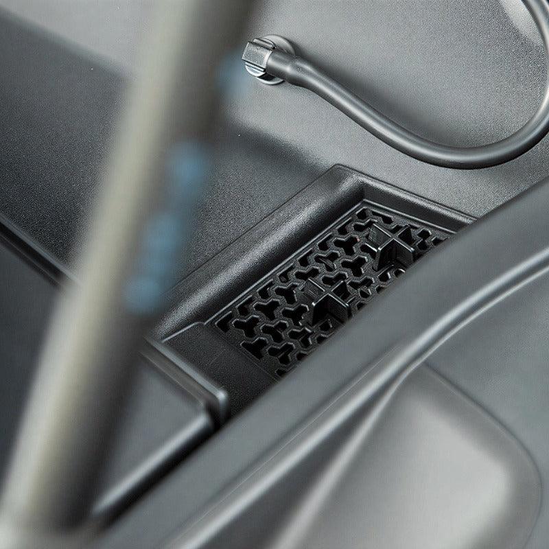Black textured plastic storage tray and organizer compartment for vehicle interior.