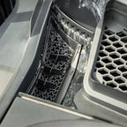 Close-up of grey TPE car floor mats featuring a waterproof hexagonal honeycomb texture.