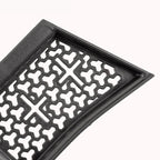 Close-up of a durable black textured rubber car floor mat with a unique honeycomb pattern.