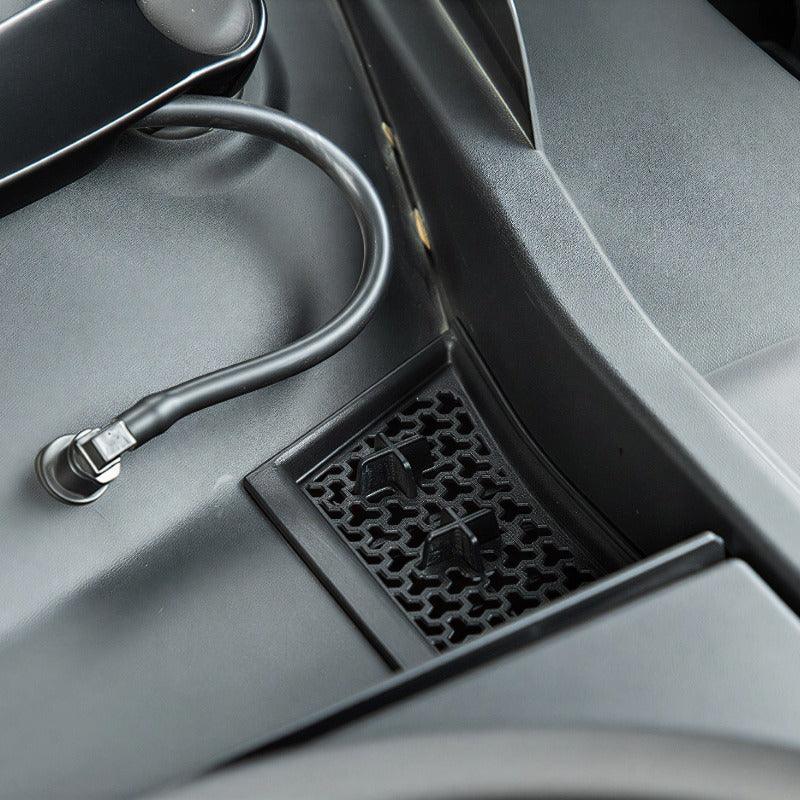 Black textured interior trim panel with a flexible black cable connection for BYD accessories.