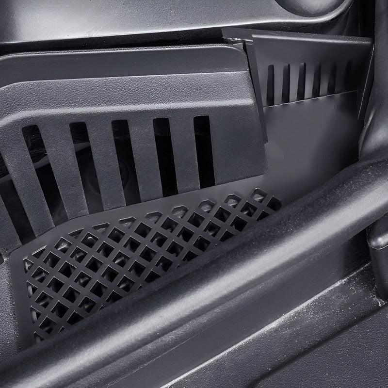 Close-up of durable black plastic car floor mats with a reinforced grid texture.