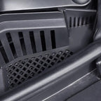 Close-up of durable black plastic car floor mats with a reinforced grid texture.
