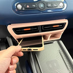 Pink ABS plastic car interior console organizer with a smartphone resting in the slot.