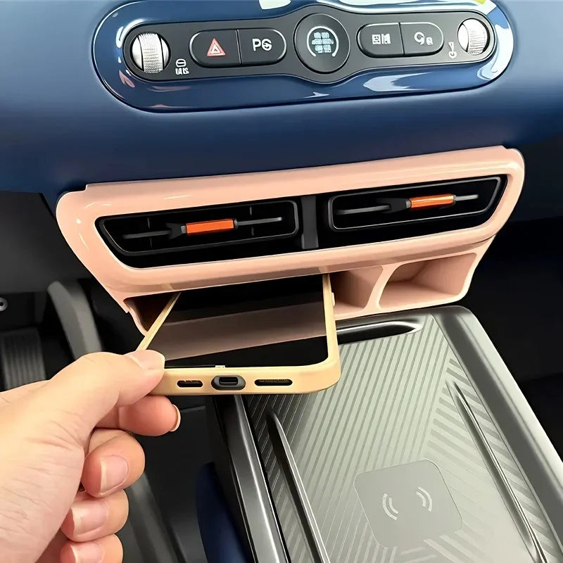 Pink ABS plastic car interior console organizer with a smartphone resting in the slot.