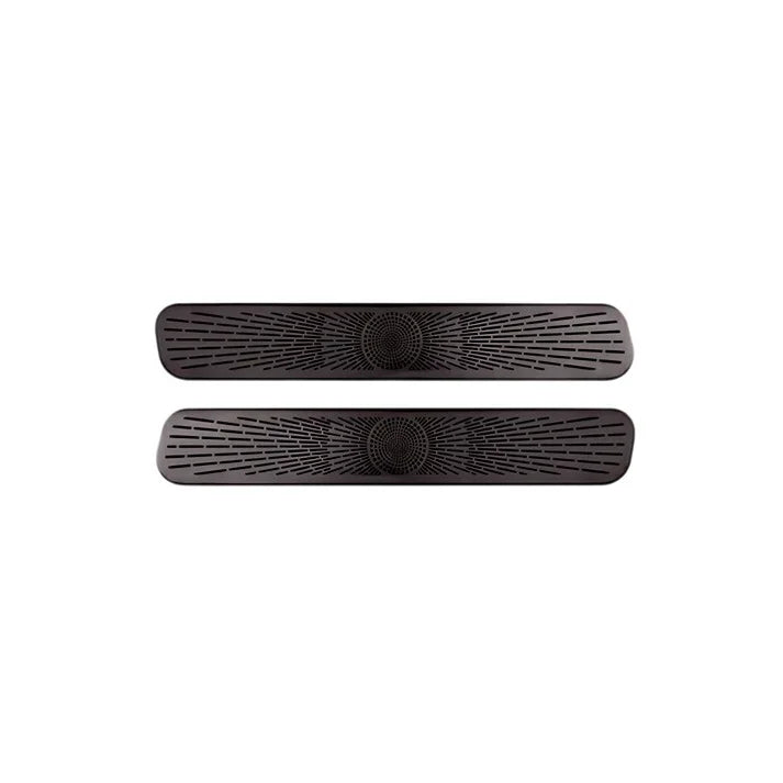 Pair of black textured anti-slip floor mats with unique radial pattern design.