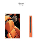 Orange Alcantara car seat upholstery with premium black carbon fiber texture accents.