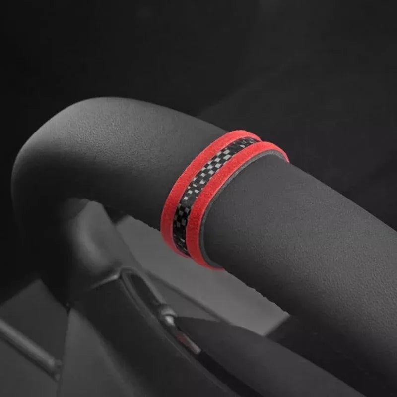 Black carbon fiber texture steering wheel cover with vibrant red trim.