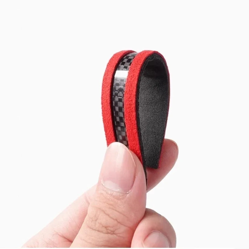 Red carbon fiber pattern protective trim strip with soft black lining for car interiors.