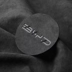 Black suede-textured circular car interior accessory with embossed BYD logo.