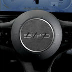 Black textured leather steering wheel cover with a sleek silver metallic trim ring.