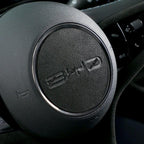 Black Alcantara steering wheel cover with silver trim and BYD logo for premium car interior protection.