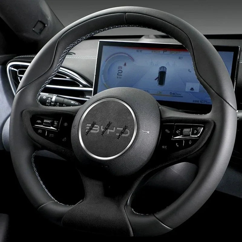 Black leather steering wheel with blue contrast stitching and integrated multimedia controls.