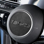 Black textured leather steering wheel cover with a sleek silver metallic trim ring.