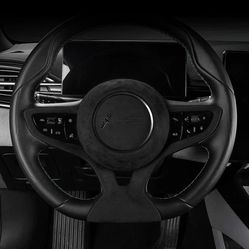 Black leather and suede steering wheel with premium stitching for BYD interior protection.