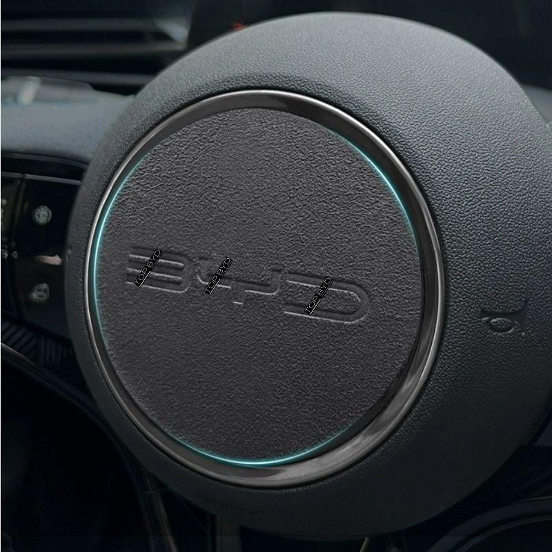 Black textured leather steering wheel cover with a sleek silver trim and subtle blue LED ring.