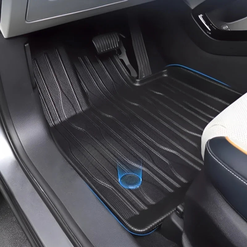 Black textured TPE car floor mat with stylish blue edge stitching for BYD protection.