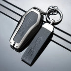 Premium black leather and polished silver metal BYD key fob cover with embossed logo.