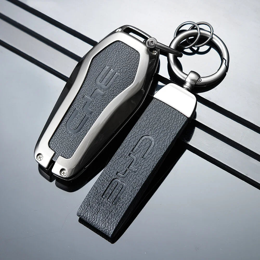 Premium black leather and polished silver metal BYD key fob cover with embossed logo.