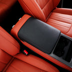 Black leather center console armrest cover for red perforated leather car seats.