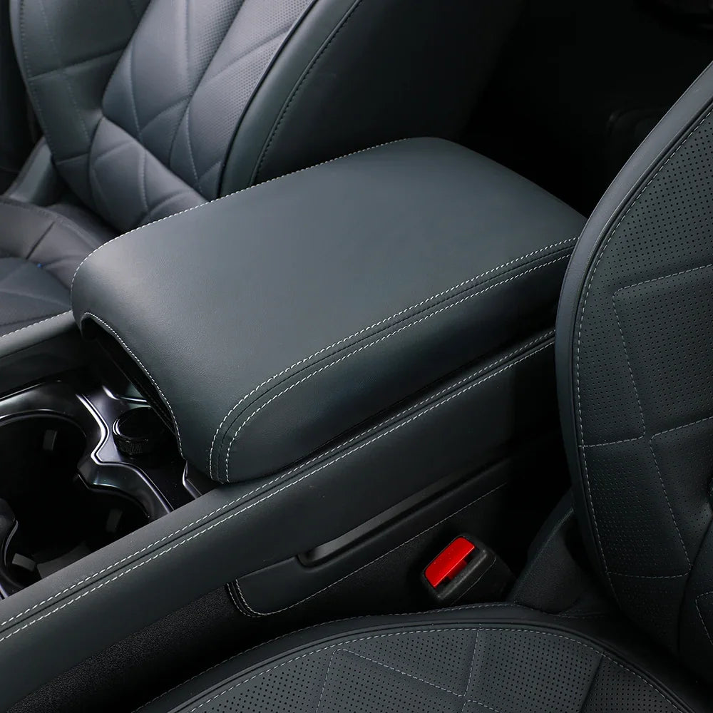 Premium dark grey leather center console armrest with white contrast stitching for BYD interior.