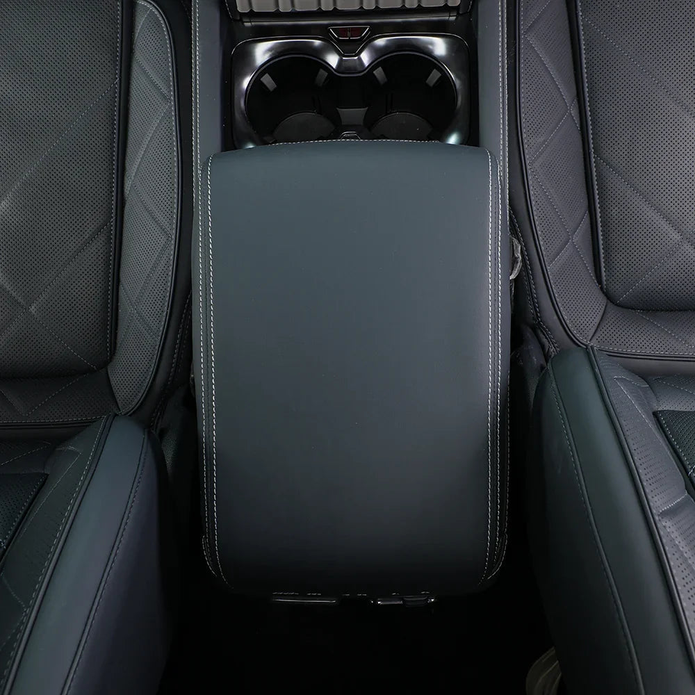Premium dark grey leather center console armrest with white contrast stitching for BYD interior.