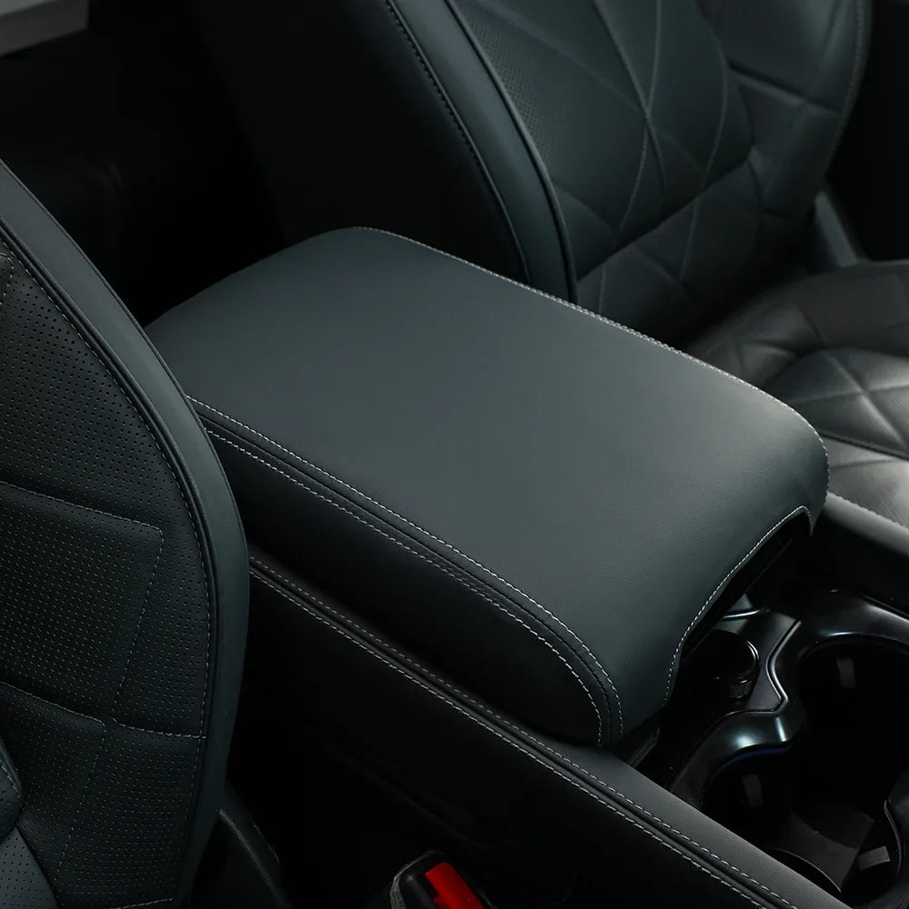 Premium dark grey leather center console armrest cover with white contrast stitching for BYD vehicles.