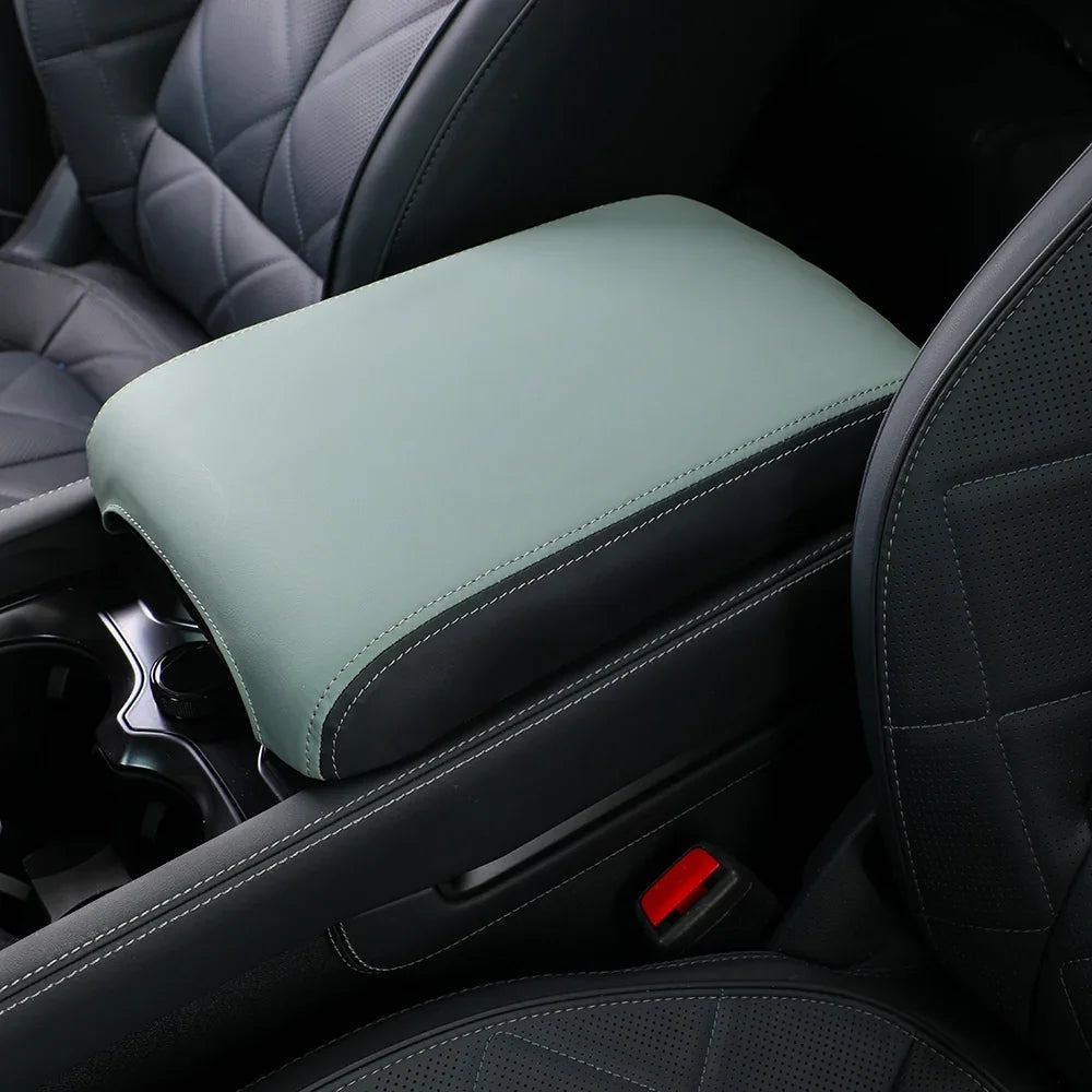 Light sage green leatherette center console armrest cover with white stitching for car interior protection