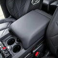Premium black leather center console armrest with diamond-stitched interior trim.