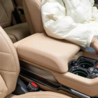 Tan leather center console armrest with premium quilted stitching for BYD car interior.