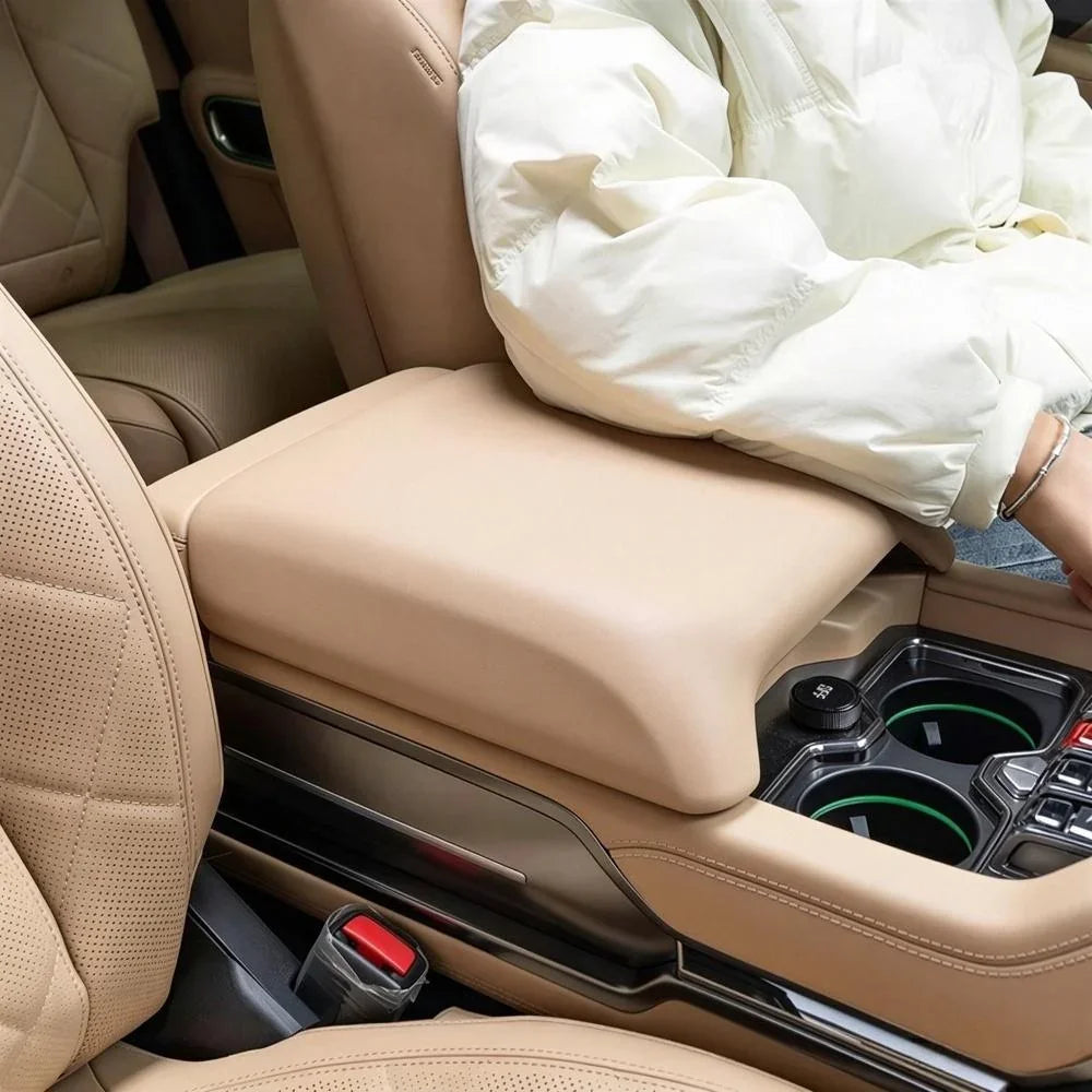 Tan leather center console armrest with premium quilted stitching for BYD car interior.