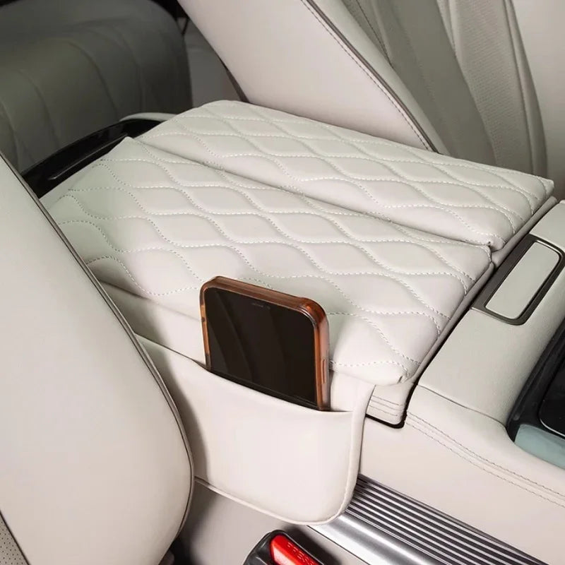 White diamond-stitched leather center console cover with integrated phone storage pocket