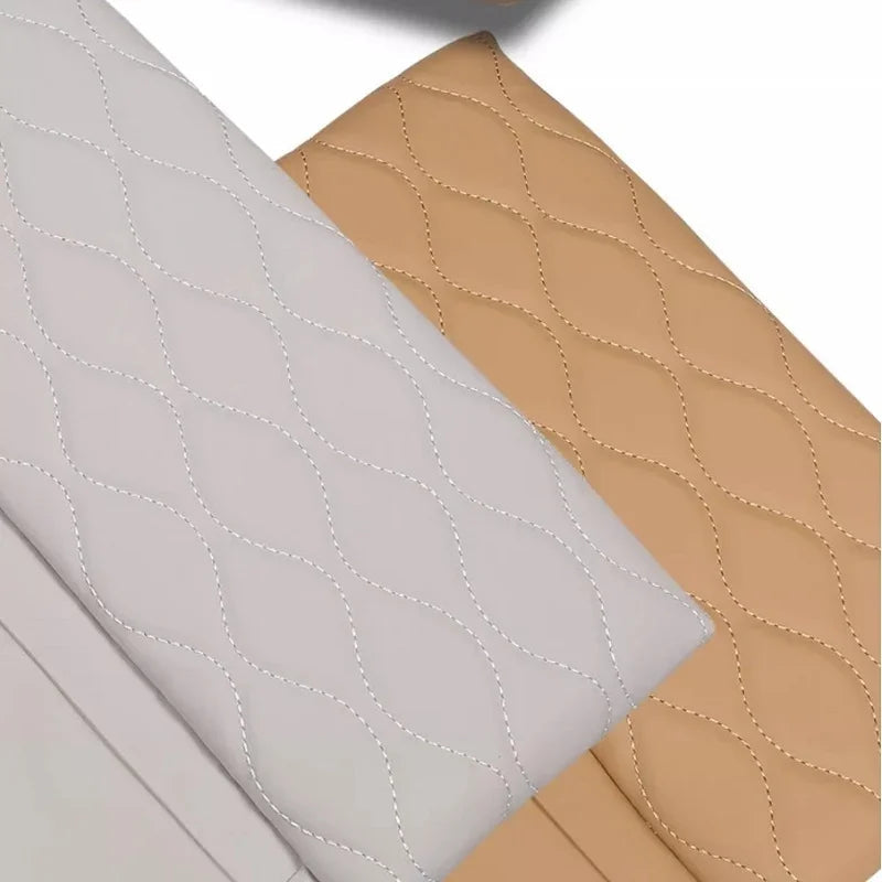 Diamond-quilted leather car seat covers in light grey and tan beige colors.