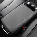 Grey perforated leather center console armrest with blue contrast stitching for BYD models.