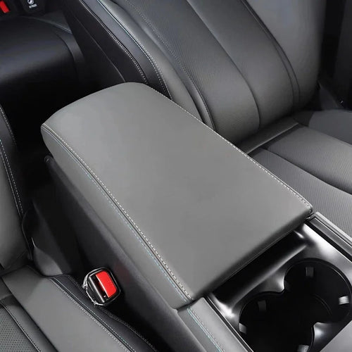 Premium grey faux leather center console armrest cover with precise blue contrast stitching.