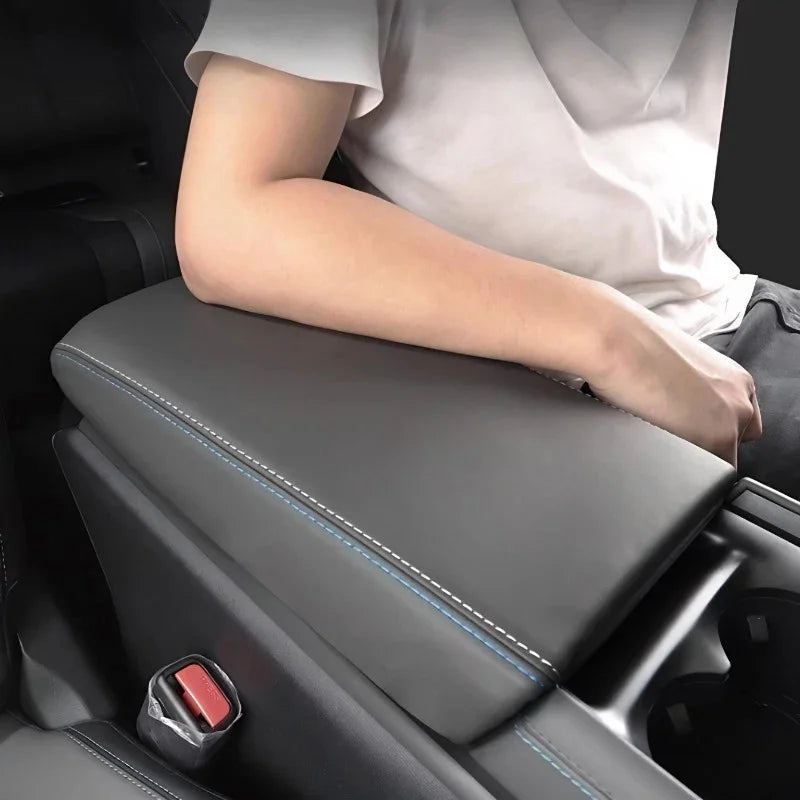 Premium grey leather armrest cover with elegant blue contrast stitching for car interior protection.