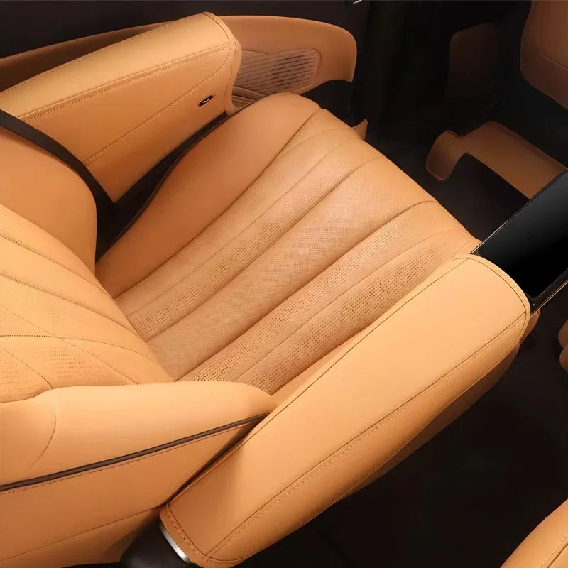 Premium tan perforated leather car seats with ergonomic design and stylish black stitching.