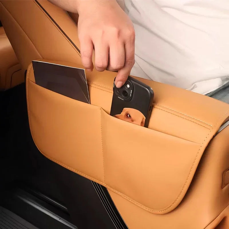Tan leather car seat back organizer with storage pockets for a smartphone and documents.