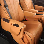 Tan leather car seats featuring diamond-stitched patterns and integrated side-pocket organizers.