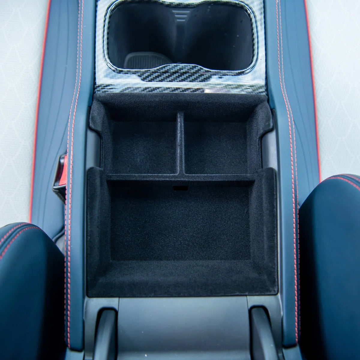 Black carbon fiber trim and black felt-lined center console organizer for BYD interior.
