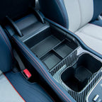 Black carbon fiber texture center console organizer with red stitching for BYD interior.