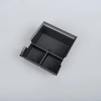 Black textured non-slip organizer tray for car center console storage.
