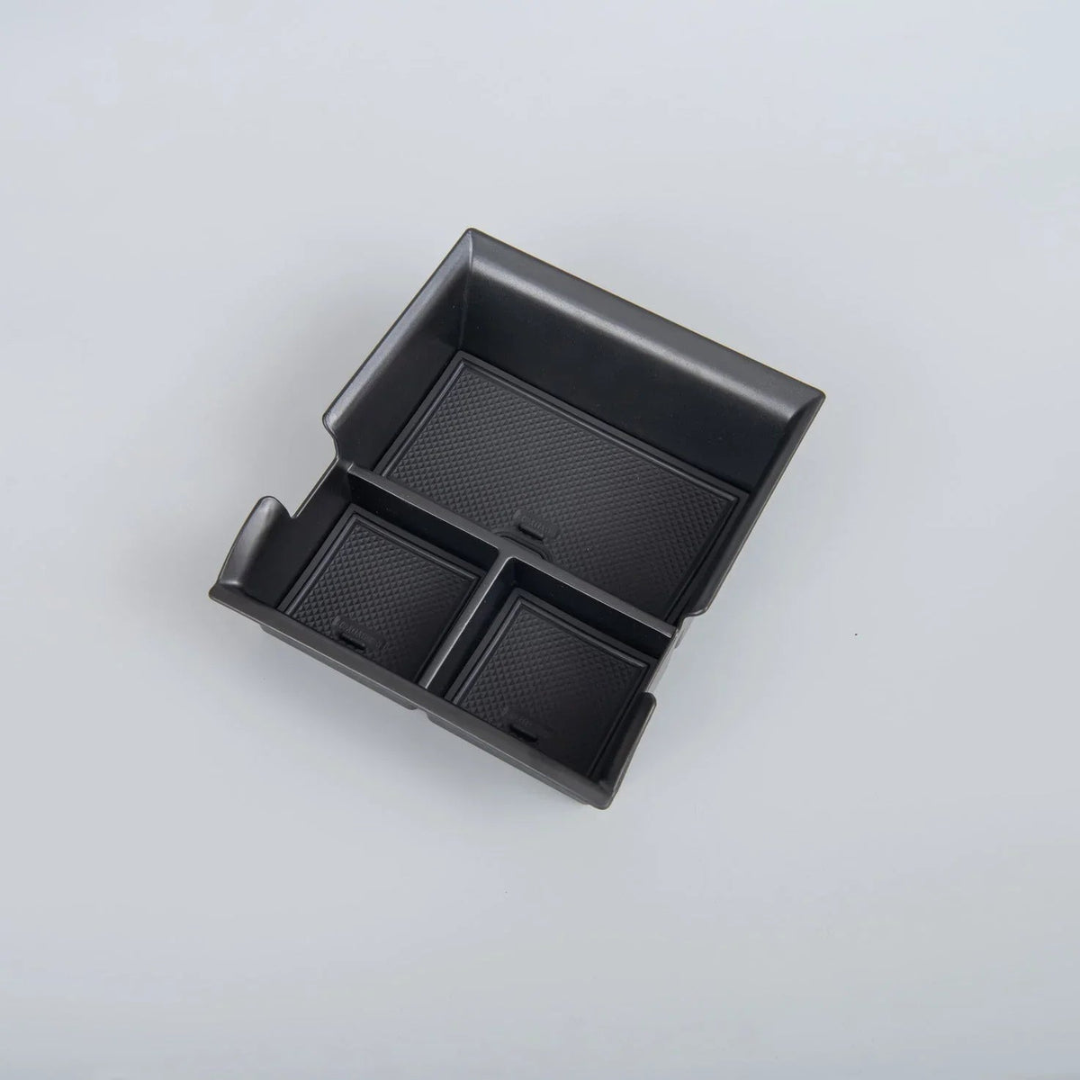 Black textured non-slip organizer tray for car center console storage.