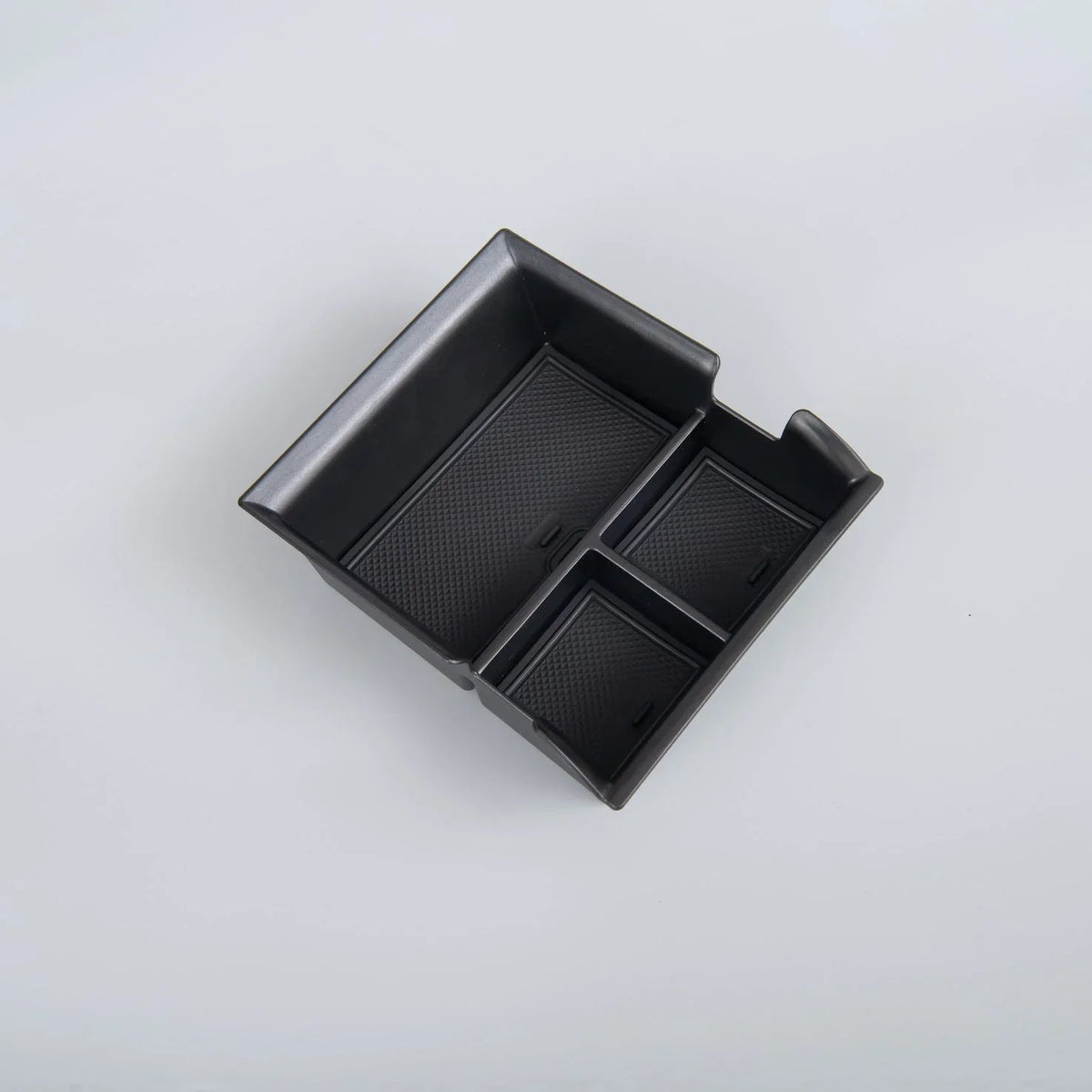 Black textured TPE car center console organizer tray for efficient storage.