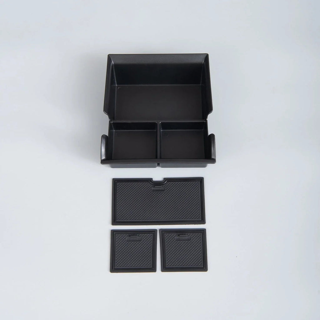 Black matte ABS plastic car center console organizer tray with anti-slip textured dividers.