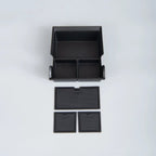 Black matte ABS plastic car center console organizer tray with anti-slip textured dividers.
