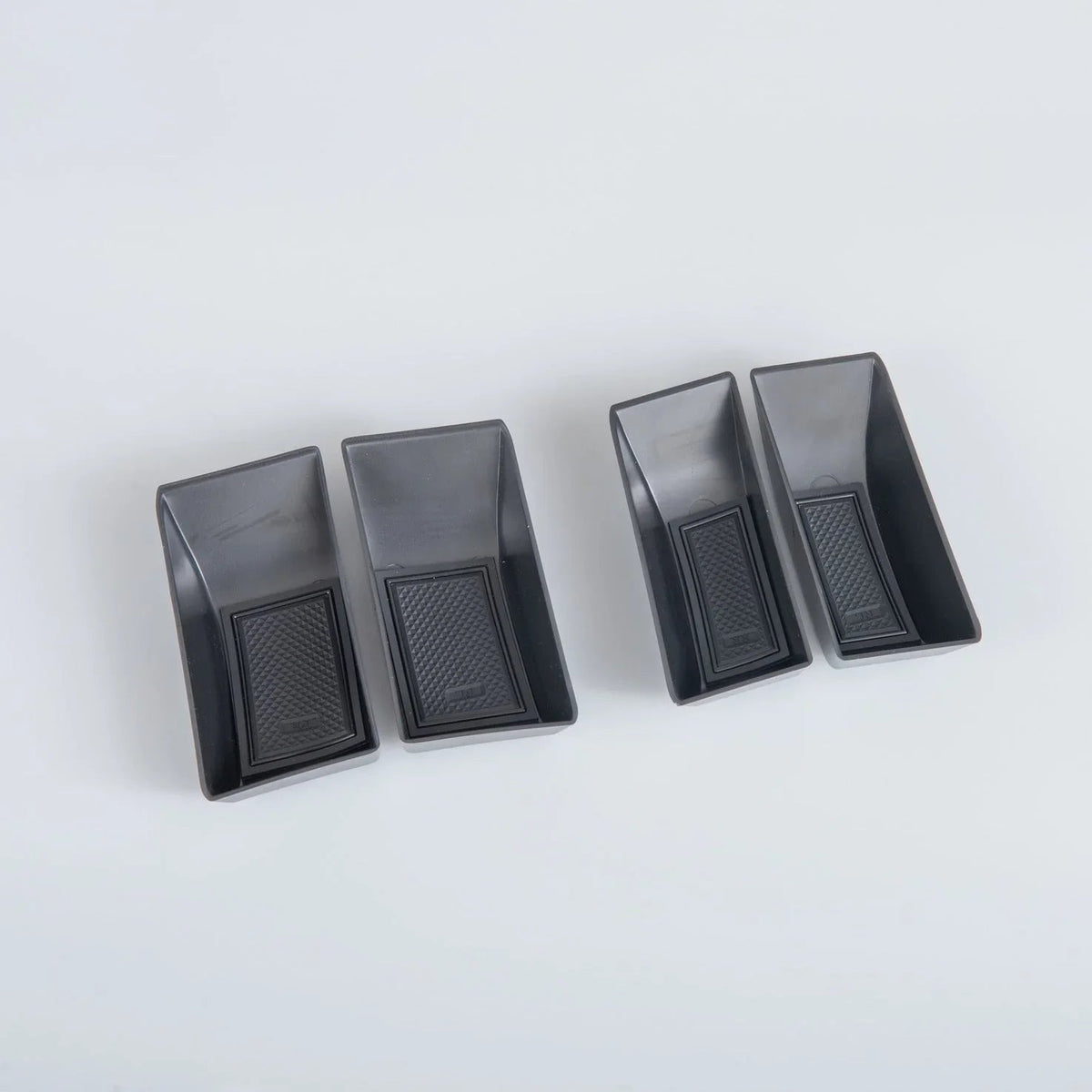 Set of four black high-density TPE car floor mats with anti-slip textured surfaces.