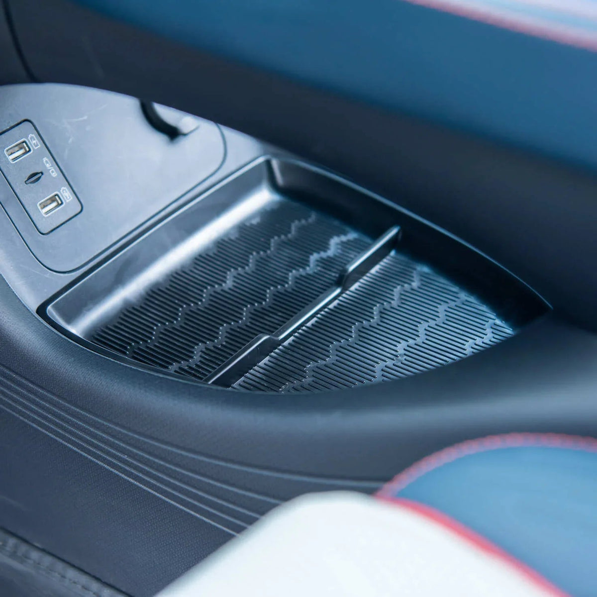 Black textured anti-slip silicone mat for car center console storage compartment.