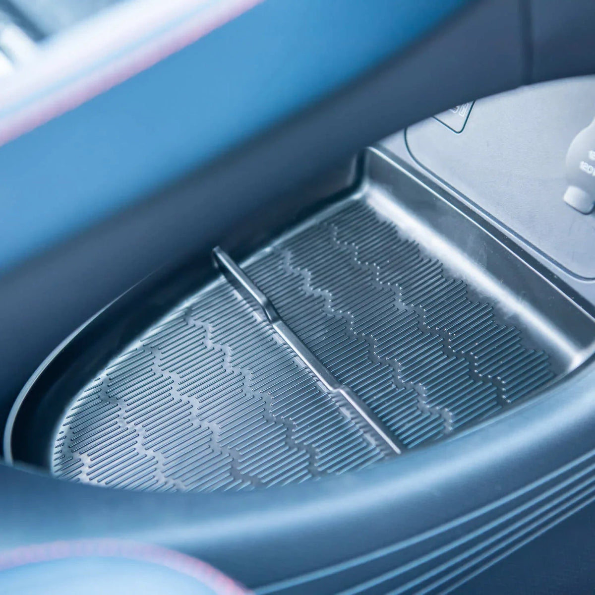 Black textured anti-slip silicone tray liner for car center console storage.