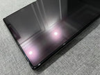 High-gloss black tempered glass screen protector with a smooth, reflective finish.